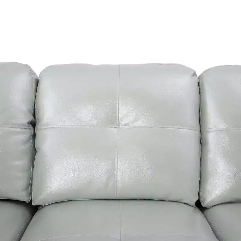 Divano componibile angolare in similpelle grigia, con rivestimento capitonné, pouf contenitore versatile, soluzione contemporanea per la zona giorno